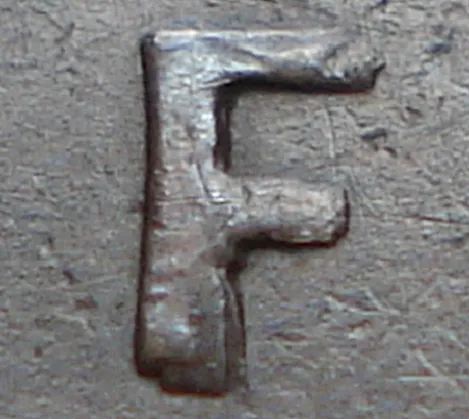 Re-engraved F in NEWF